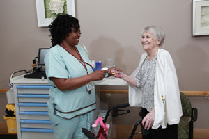 a nurse talking to an elderly woman